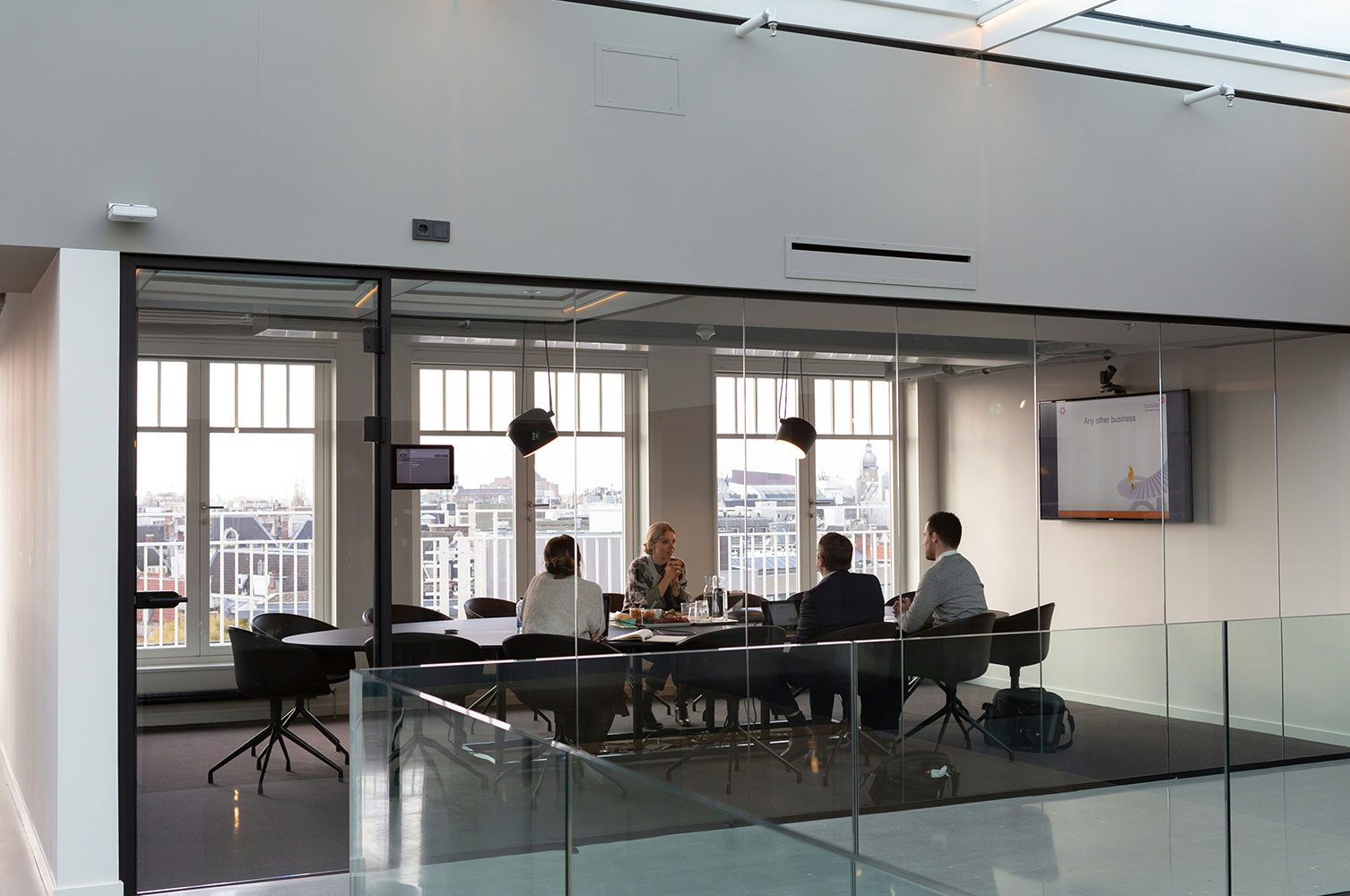 View into a conference room of people meeting in an office