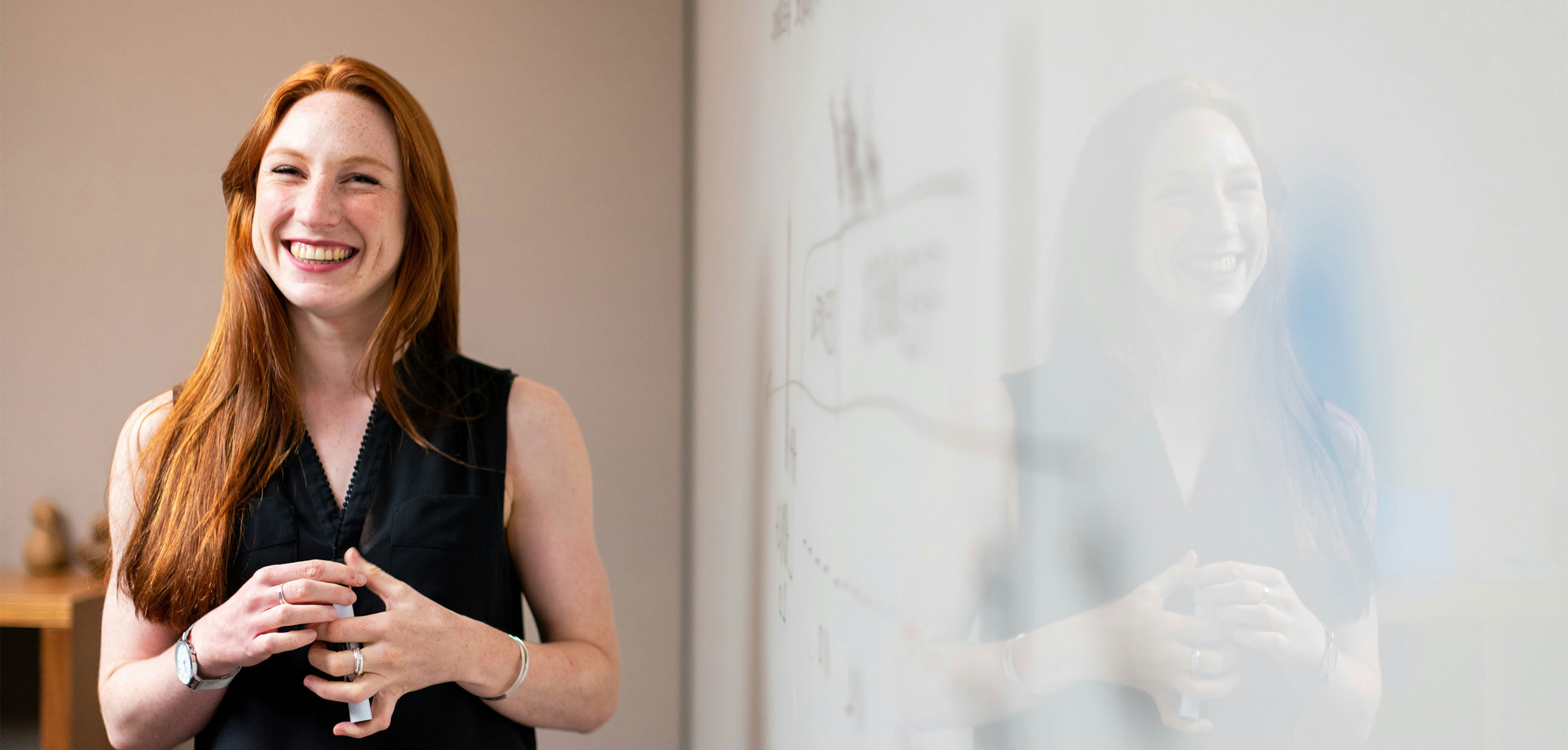 Woman at whiteboard presenting